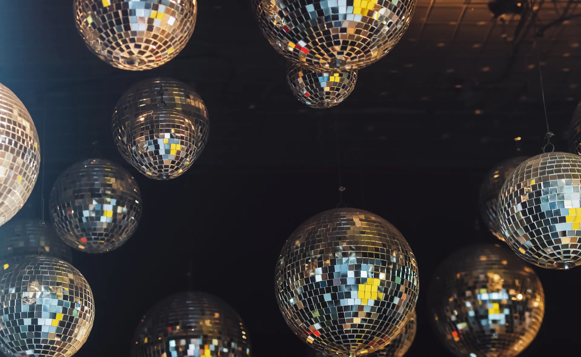 Disco ball reflections and party atmosphere at The Main Event venue